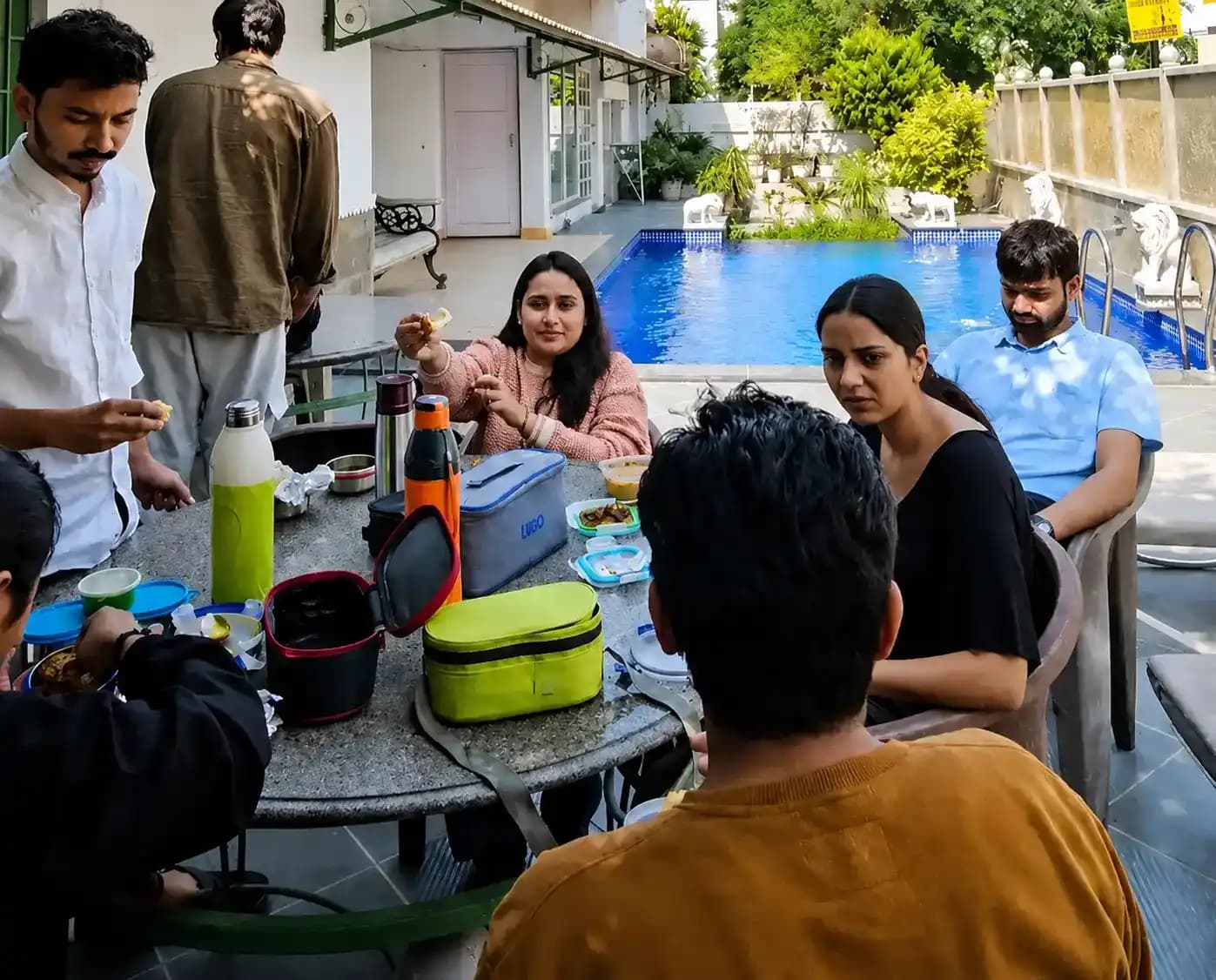 Influish team reviewing work together around a laptop